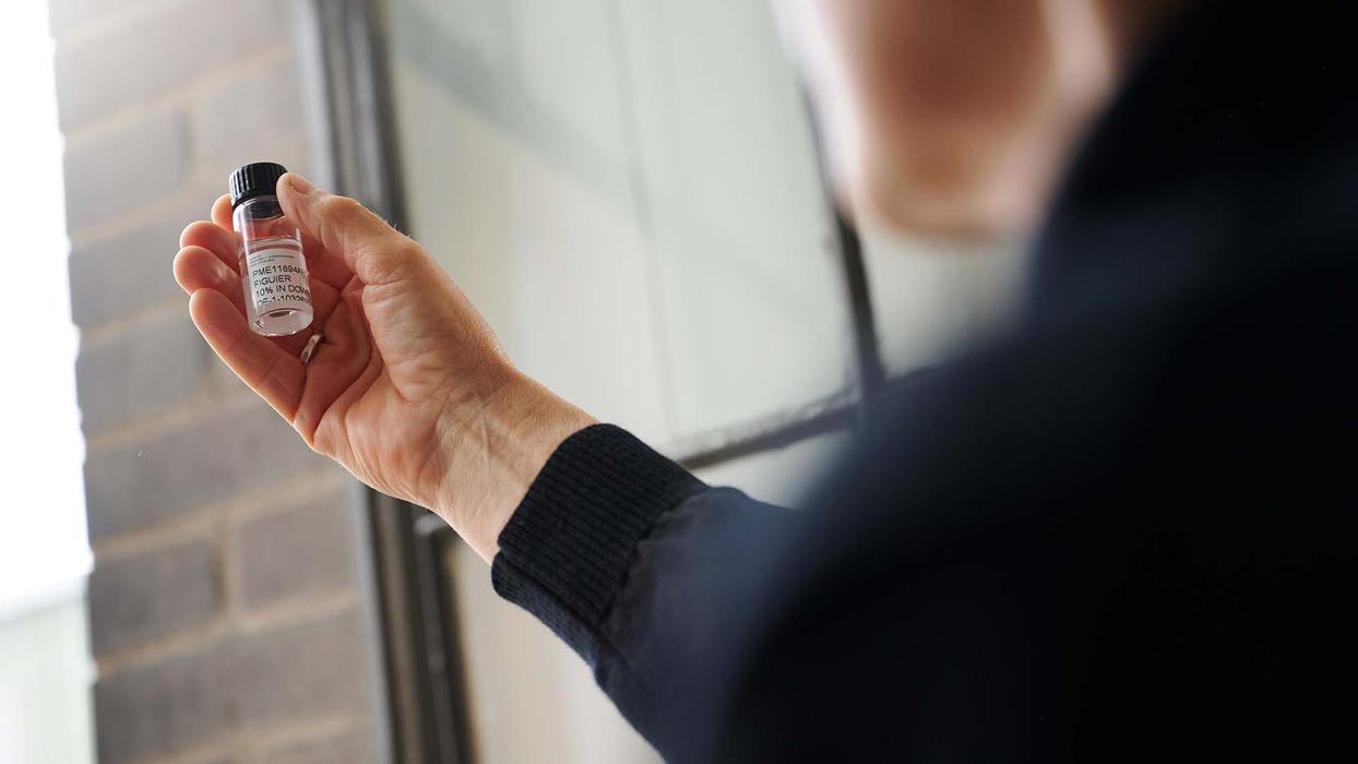 A hand holding a frangrance