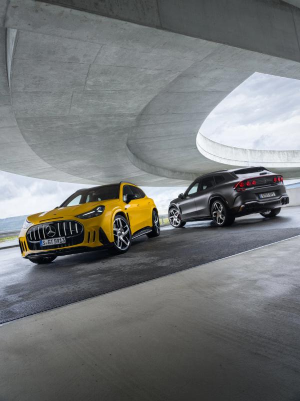 The Mercedes-AMG GT 55 and 63 SUVs are parked beneath a motorway slip road