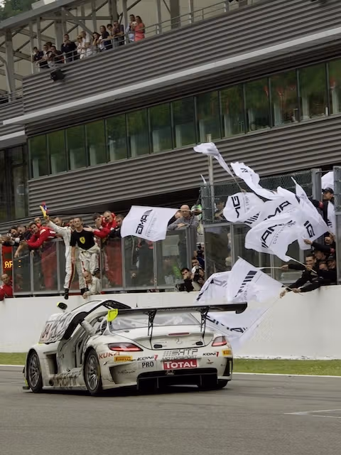 AMG GT racing car on the lap of honour around the pit lane