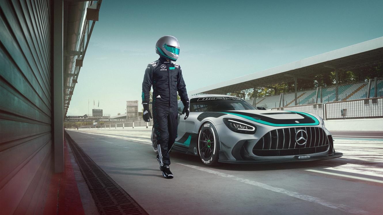 Racing driver runs alongside parked Mercedes-AMG GT2 Edition W16