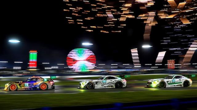 Three Mercedes-AMG GTs with fireworks in the background