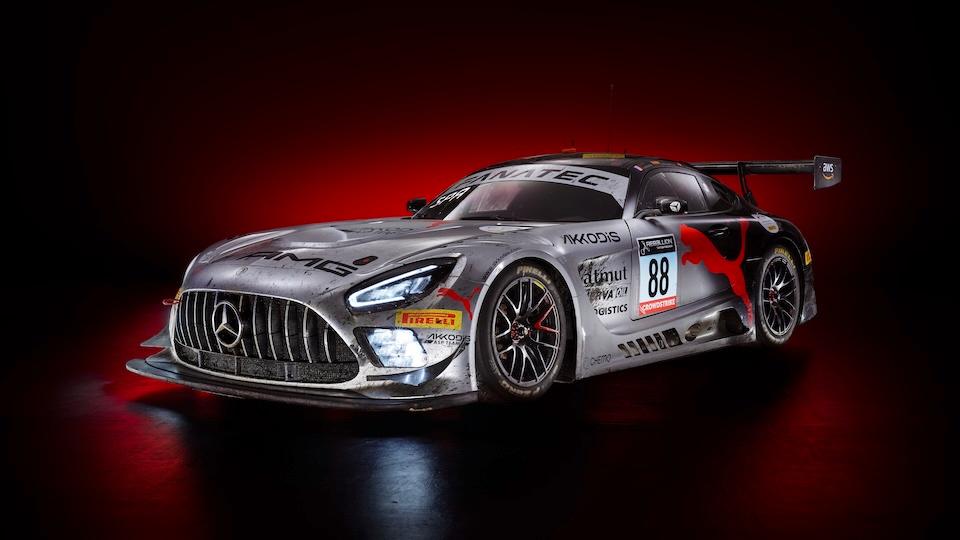 Mercedes-AMG GT racing car against a black and red background.