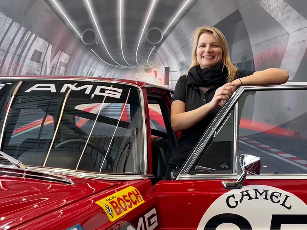 AMG Allstar Daniela stands in front of the 'rote Sau'