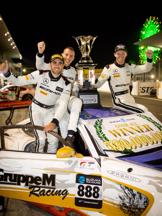 Three drivers sit on their GT vehicle and cheer